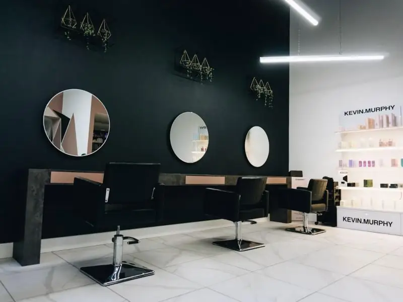 Salon chairs facing round mirrors