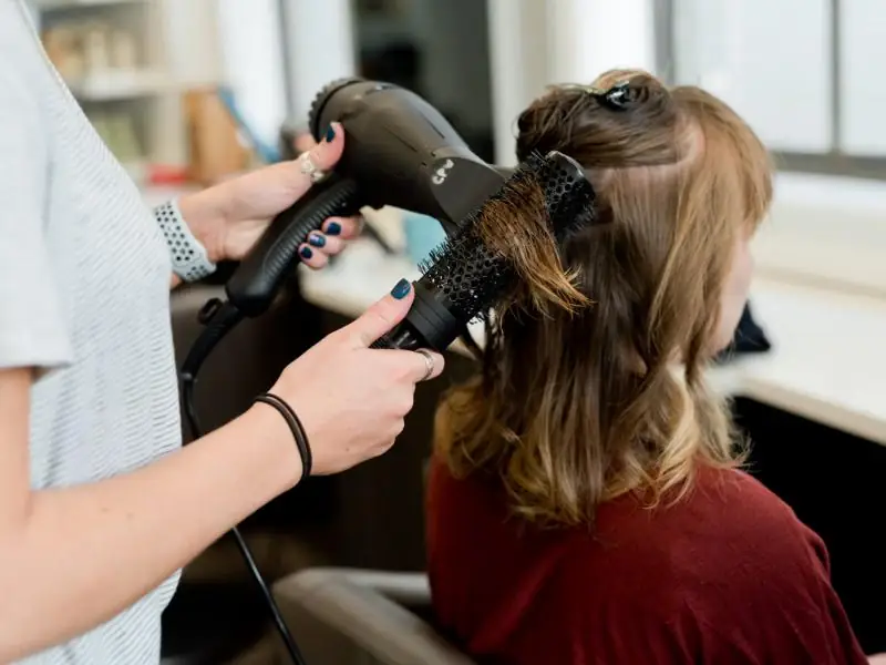 A stylist finishing a blow-dry