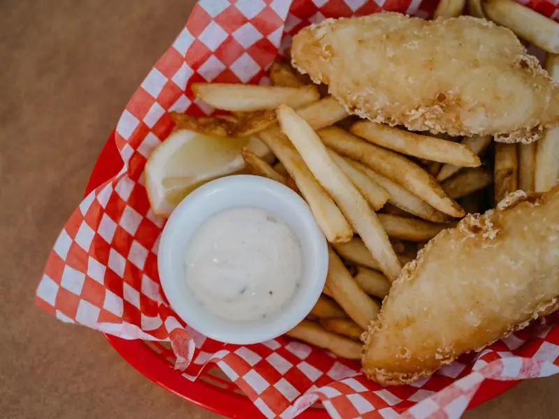 Battered fish and chips in a paper-lined basket